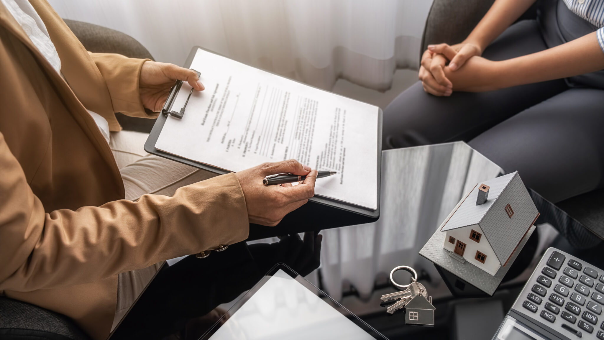 midsection woman holding paper while sitting table